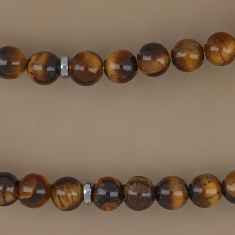 Collier pour homme en acier et pierre œil de tigre, design inspiré de la culture amérindienne Navajo.
